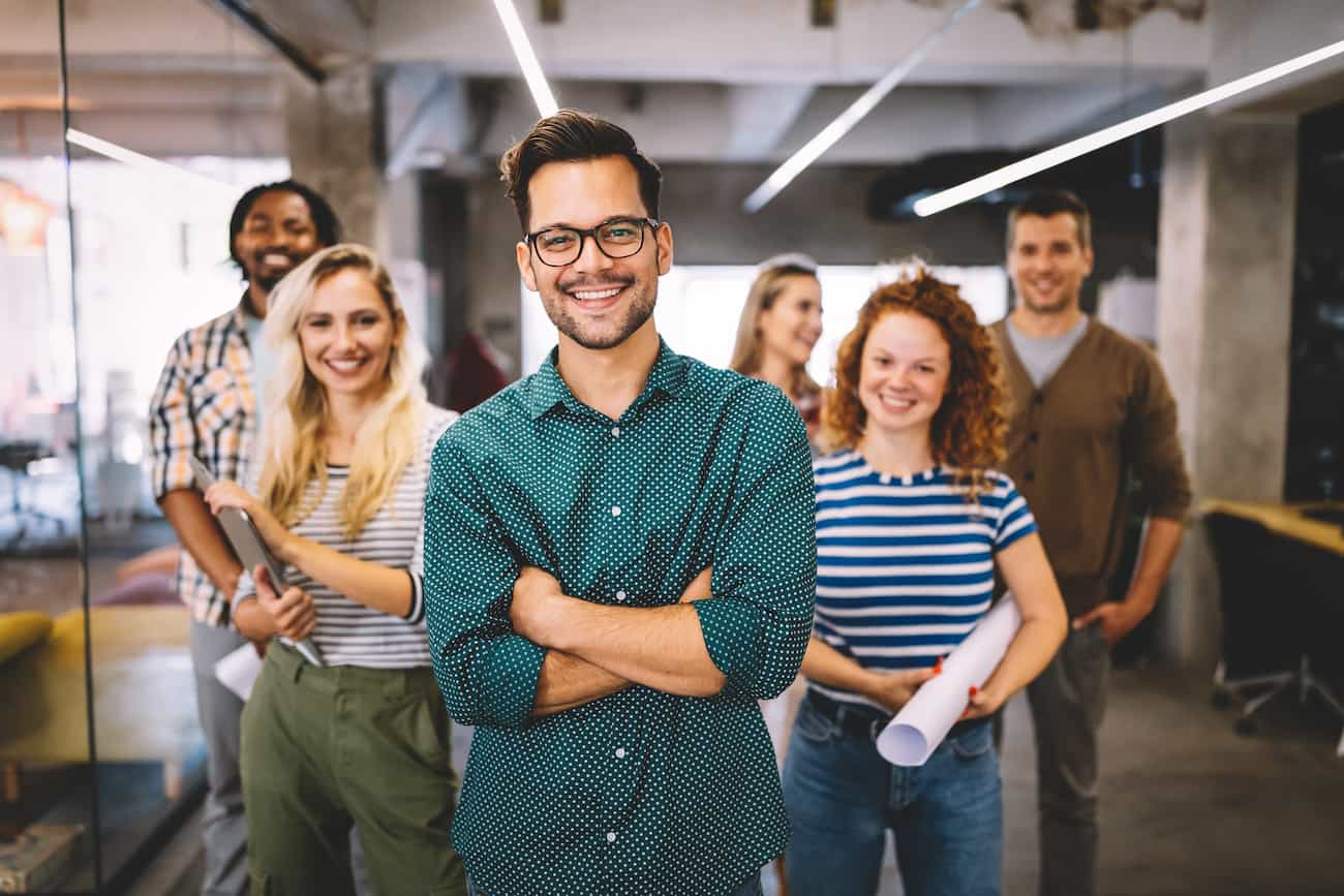 Fröhliches Team junger Fachkräfte im modernen Büro, symbolisiert die Gewinnung wertvoller Nutzer-Insights und die Optimierung der Benutzerfreundlichkeit digitaler Angebote.